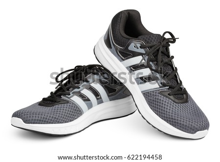 MOSCOW, RUSSIA - APRIL 7, 2017: Pair of new gray Adidas sport running shoes, sneakers or trainers isolated on white background with clipping path