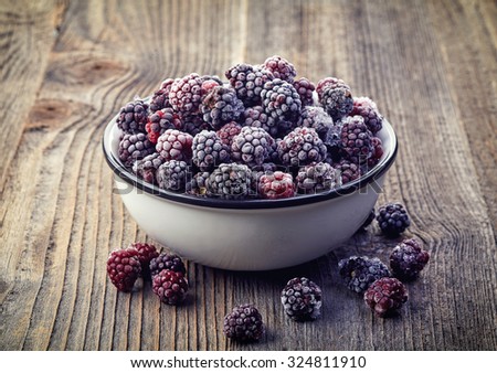 Delicious juicy raspberries in a wooden bowl Top view