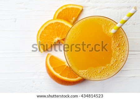 Glass of fresh orange juice from top view