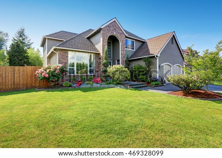 luxury house exterior with brick and siding trim and double garage well kept garden around - Luxury Homes Exterior Brick luxury house exterior with brick and siding trim and double garage well kept garden around - Luxury Homes Exterior Brick