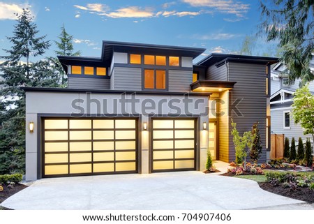 Beautiful exterior of contemporary home with two car garage spaces at sunset northwest usa Beautiful exterior of contemporary home with two car garage spaces at sunset northwest usa