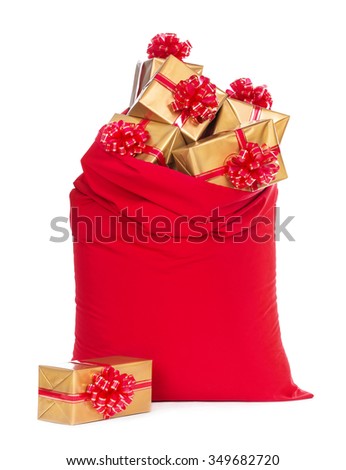 Red big Santa Christmas sack full of and surrounded by golden wrapped gift boxes with bows isolated on a white background