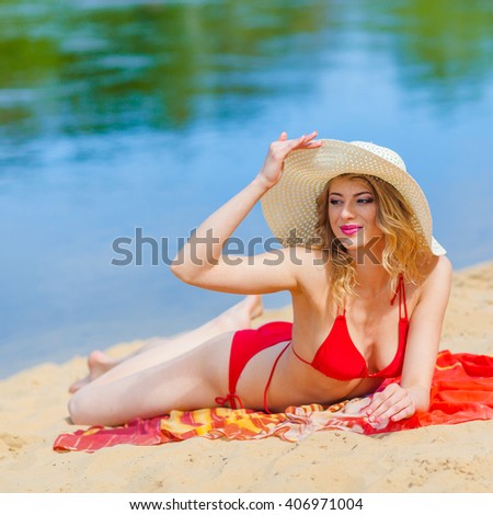 https://thumb1.shutterstock.com/display_pic_with_logo/511507/406971004/stock-photo-girl-in-a-red-bikini-sunbathing-on-the-beach-sexy-blonde-woman-sunbathing-by-the-sea-406971004.jpg