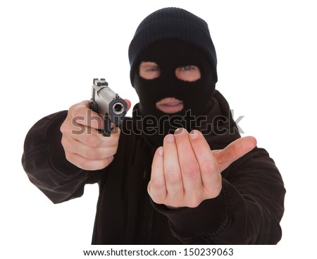 stock-photo-burglar-wearing-mask-aiming-gun-towards-camera-150239063.jpg