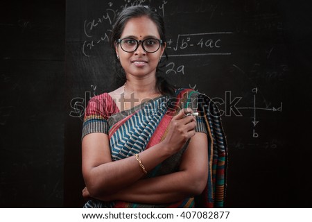 stock photo portrait of indian lady teacher stands in front of a blackboard 407082877