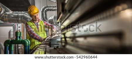 Portrait of a worker, constructing and checking development of a small business hall. Reliable civil engineer working on a construction site, foreman at work