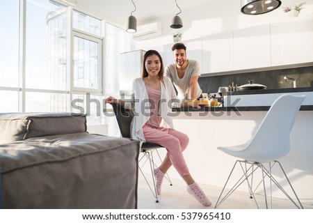 https://thumb1.shutterstock.com/display_pic_with_logo/534712/537965410/stock-photo-young-couple-having-breakfast-asian-woman-hispanic-man-cooking-food-kitchen-modern-apartment-537965410.jpg