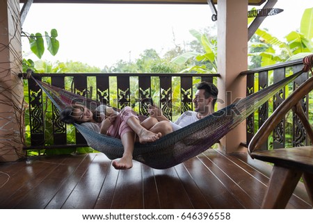 https://thumb1.shutterstock.com/display_pic_with_logo/534712/646396558/stock-photo-young-couple-lying-in-hammock-on-terrace-tropical-hotel-man-and-woman-using-cell-smart-phone-646396558.jpg