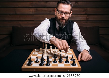 Serious male chess player makes victory move