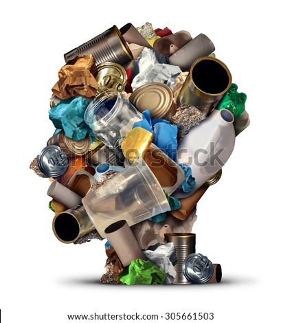 Recycling ideas and environmental garbage management solutions and creative ways to reuse waste as old paper glass metal and plastic bottles shaped as a human head as a symbol for reusable thinking.