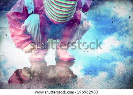 stylized photo of cute little girl is playing in muddy puddles