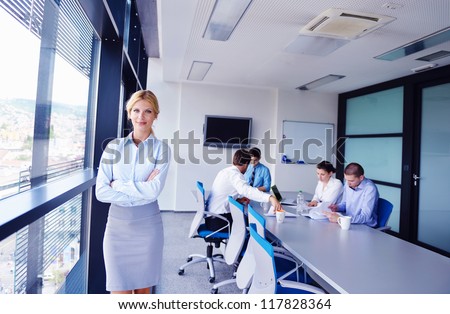 business woman with her staff, people group in background at modern bright office indoors