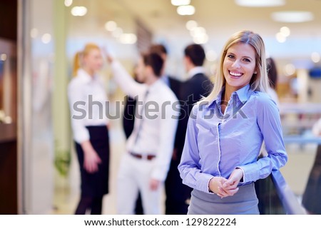 business woman with her staff, people group in background at modern bright office indoors