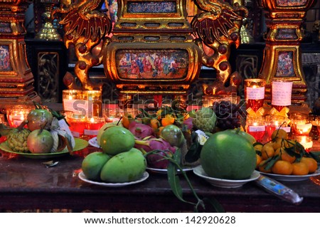 CAN THO - FEB 17: Unidentified believers offering food and incense sticks for the Gods in the Vietnamese Ong Buddhist temple. On February 17, 2013, in Can Tho, Mekong Delta, Vietnam