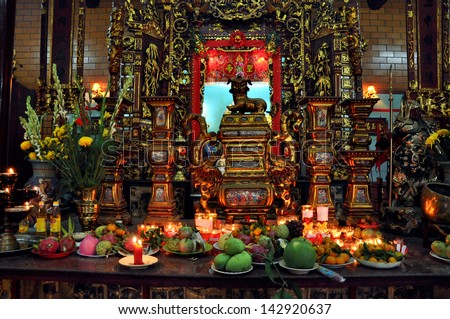 CAN THO - FEB 17: Unidentified believers offering food and incense sticks for the Gods in the Vietnamese Ong Buddhist temple. On February 17, 2013, in Can Tho, Mekong Delta, Vietnam