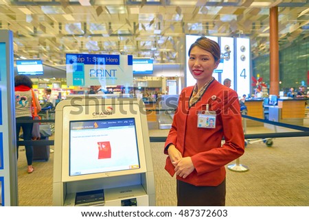 SINGAPORE - CIRCA AUGUST, 2016: indoor portrait of a woman near self check-in kiosk at Changi Aiport. Changi Airport is the primary civilian airport for Singapore.