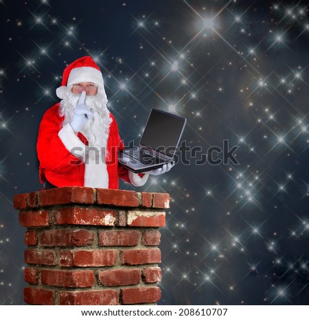 Santa Claus partially inside a chimney with a laptop and making the shh sign with a finger to his lips on a starry night background.