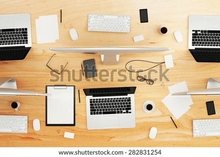 top view of wooden conference table with office accessories and computers