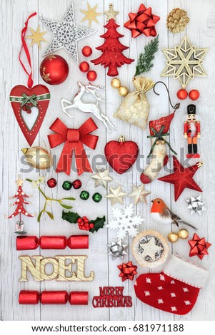 Christmas festive decorations with gold noel sign, old fashioned and new baubles, holly, mistletoe, fir and mince pie on rustic white wood background.