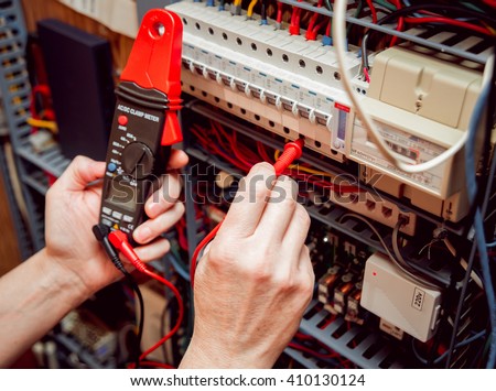 Electrical equipment. Tester in the hands. Background and texture