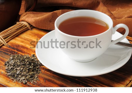 A cup of whole leaf lapsang souchong tea, a rich smoky flavored tea