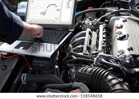 Professional car mechanic working in auto repair service.