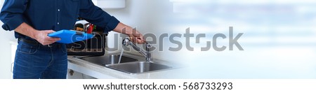 Plumber hands with clipboard.