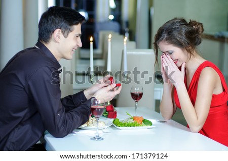 https://thumb1.shutterstock.com/display_pic_with_logo/559060/171379124/stock-photo-marriage-proposal-man-give-ring-to-his-girl-young-happy-couple-romantic-date-at-restaurant-171379124.jpg