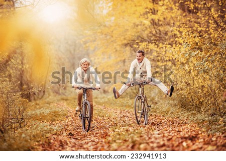 Active seniors on bikes in autumn nature
