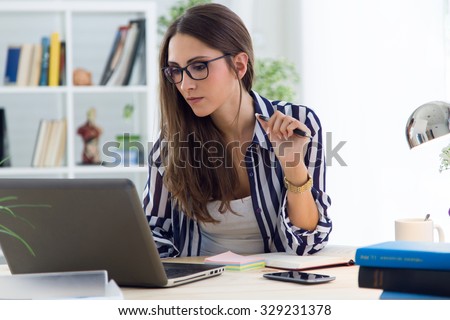 Portrait of beautiful young woman working in the office.