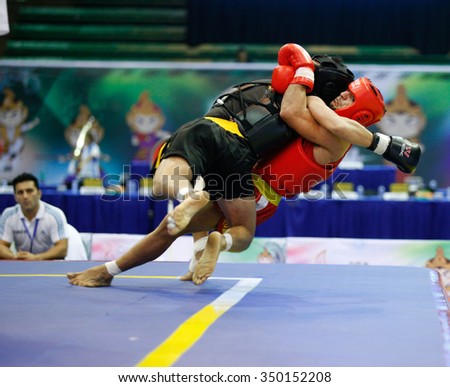 JAKARTA, INDONESIA - NOVEMBER 16, 2015: Mohsen Mohammadseifi of Iran (red) fights Van Tai Nguyen of Vietnam (black) in the men's 70kg Sanda event at the 13th World Wushu Championship 2015.