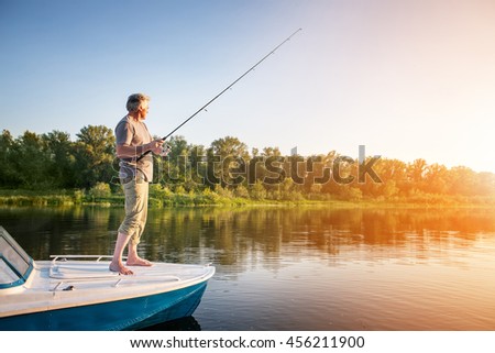 Mature man on a motor boat. Fishing