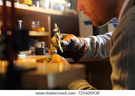 Jeweler measuring a ring with compass divider