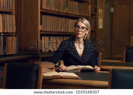 https://thumb1.shutterstock.com/display_pic_with_logo/571009/1039248307/stock-photo-beautiful-blonde-woman-wearing-elegant-black-tweed-jacket-and-glasses-sitting-at-desk-beside-1039248307.jpg