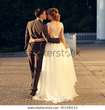 https://thumb1.shutterstock.com/display_pic_with_logo/571009/451340113/stock-photo-young-just-married-caucasian-couple-walking-away-in-sunset-lightning-451340113.jpg