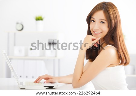 happy young asian woman using a laptop