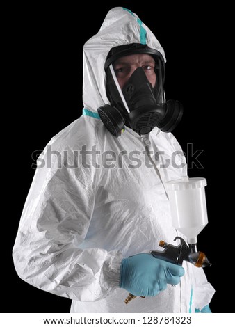 Spray painter wearing white coverall, respirator and spray gun shot over black background