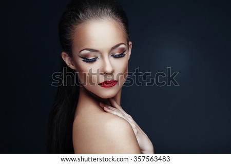 Portrait of beautiful woman with nice makeup on dark background