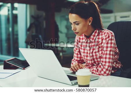 Young woman working on laptop in the office