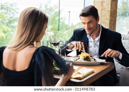 https://thumb1.shutterstock.com/display_pic_with_logo/580987/311498783/stock-photo-couple-eating-in-restaurant-with-a-red-wine-311498783.jpg