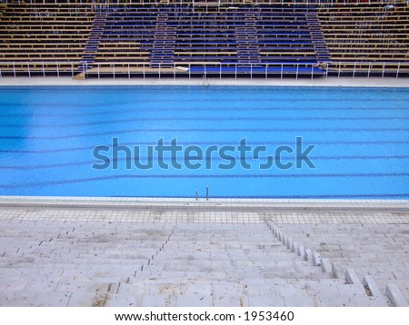 trembling surface of an olympic size swimming pool in empty sport arena - Olympic Size Swimming Pool trembling surface of an olympic size swimming pool in empty sport arena - Olympic Size Swimming Pool