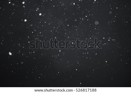 Falling snow on black background