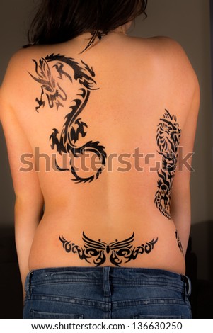 Young Sexy Women With Tribal Dragon Tattoos On Her Back Young Sexy Women With Tribal Dragon Tattoos On Her Back
