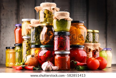 Jars with variety of pickled vegetables. Preserved food