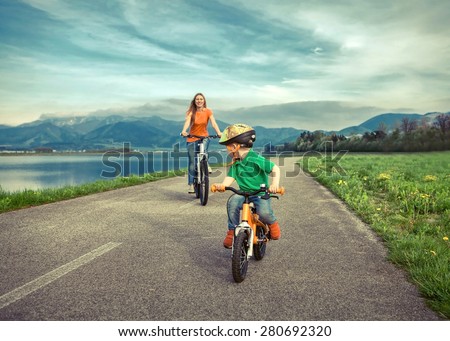 Happiness Mother and son on the bicycles funning outdoor