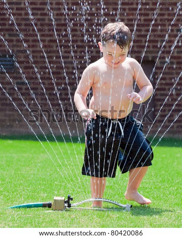 kids playing in sprinkler