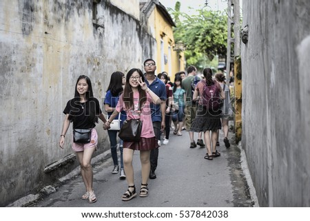 HOI AN, VIETNAM - NOVEMBER 24, 2016: Tourists visit Hoi An ancient town. Hoi An is a popular tourist destination of Asia. Hoi An is recognized as a World Heritage Site by UNESCO.