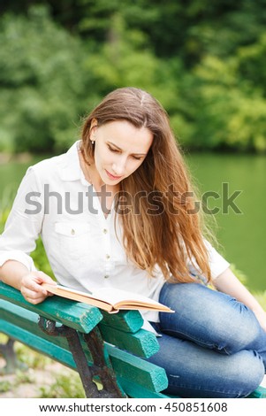 https://thumb1.shutterstock.com/display_pic_with_logo/593546/450851608/stock-photo-young-woman-sitting-in-park-near-pond-and-reading-book-pretty-caucasian-girl-with-book-relax-on-450851608.jpg