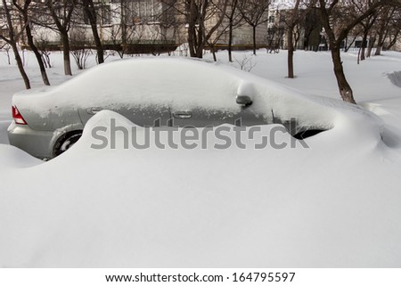 Car covered in snow after a blizzard