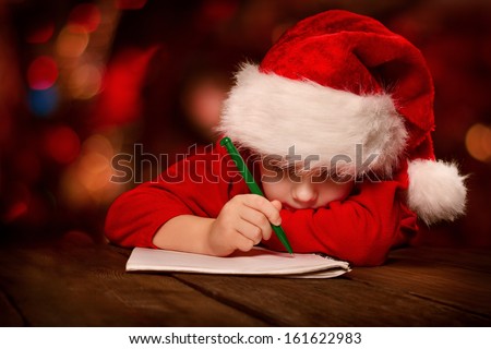 Christmas helper child writing letter to Santa Claus letter in red hat